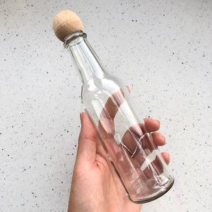 Thin glass bottle with wooden cap